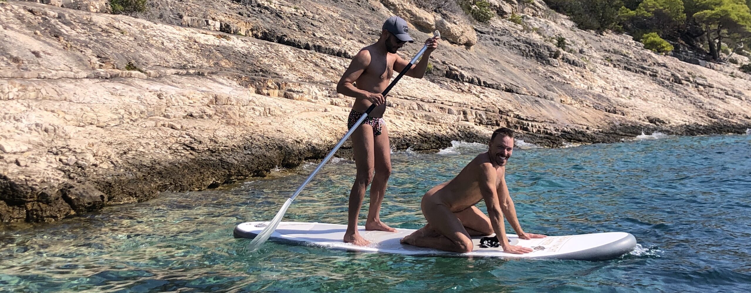 Naked and in speedo peddle board SUP 2 Saltyboys